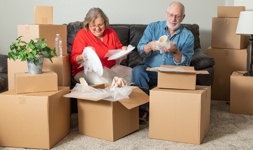 elderly couple unpacking their home